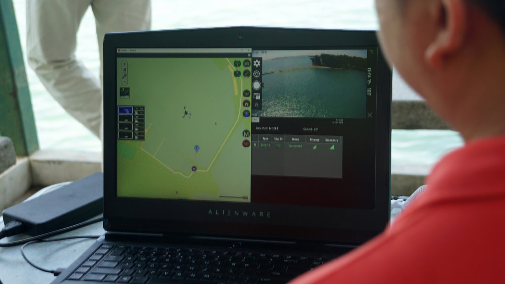 GovTechie watching the video data transmitted from the drone to laptop