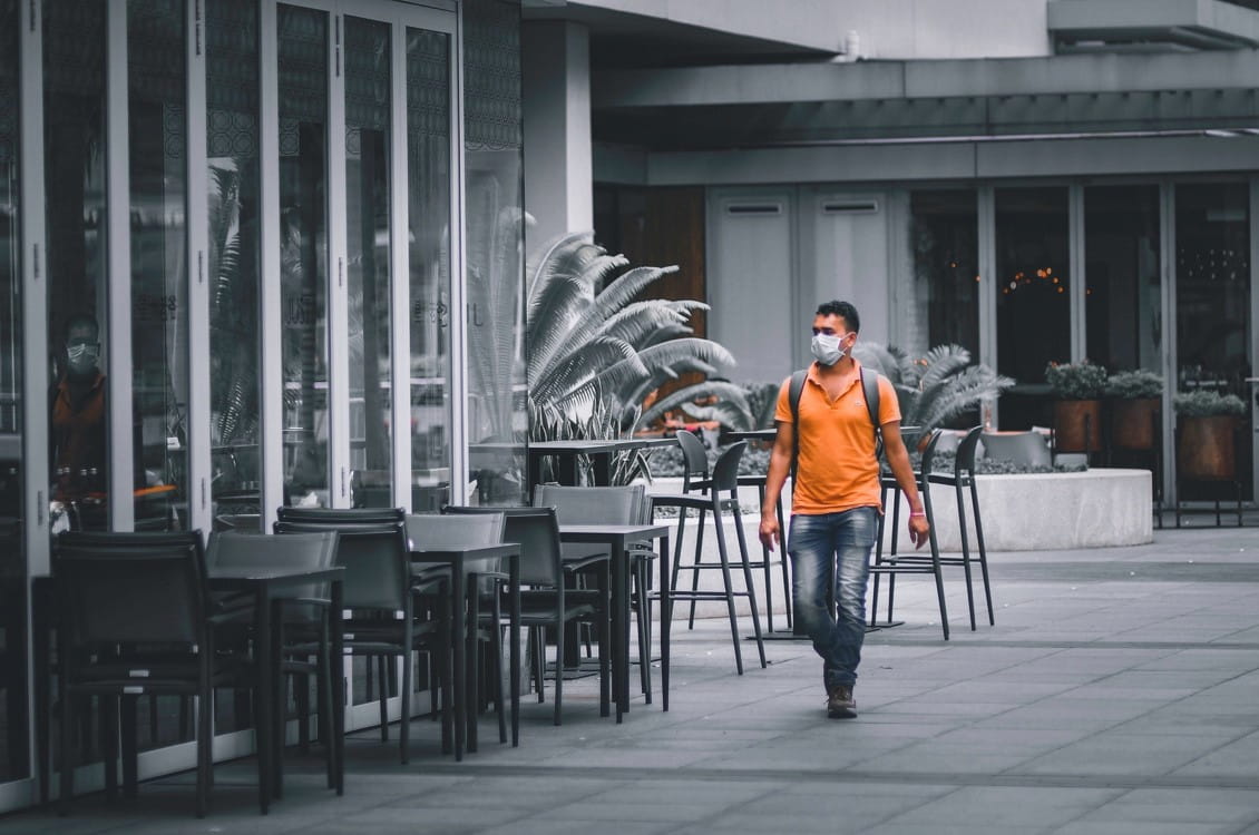 An employee walking down the street, empty due to circuit breaker