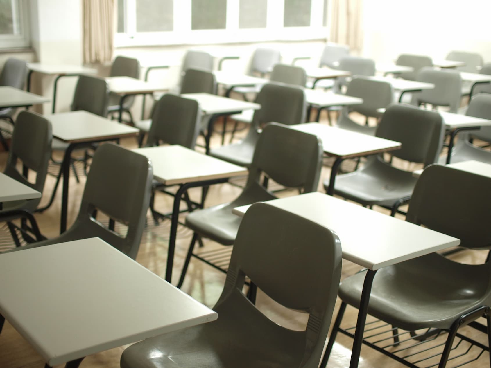 Classroom filled with tables and chairs, ready for students returning to school post COVID-19