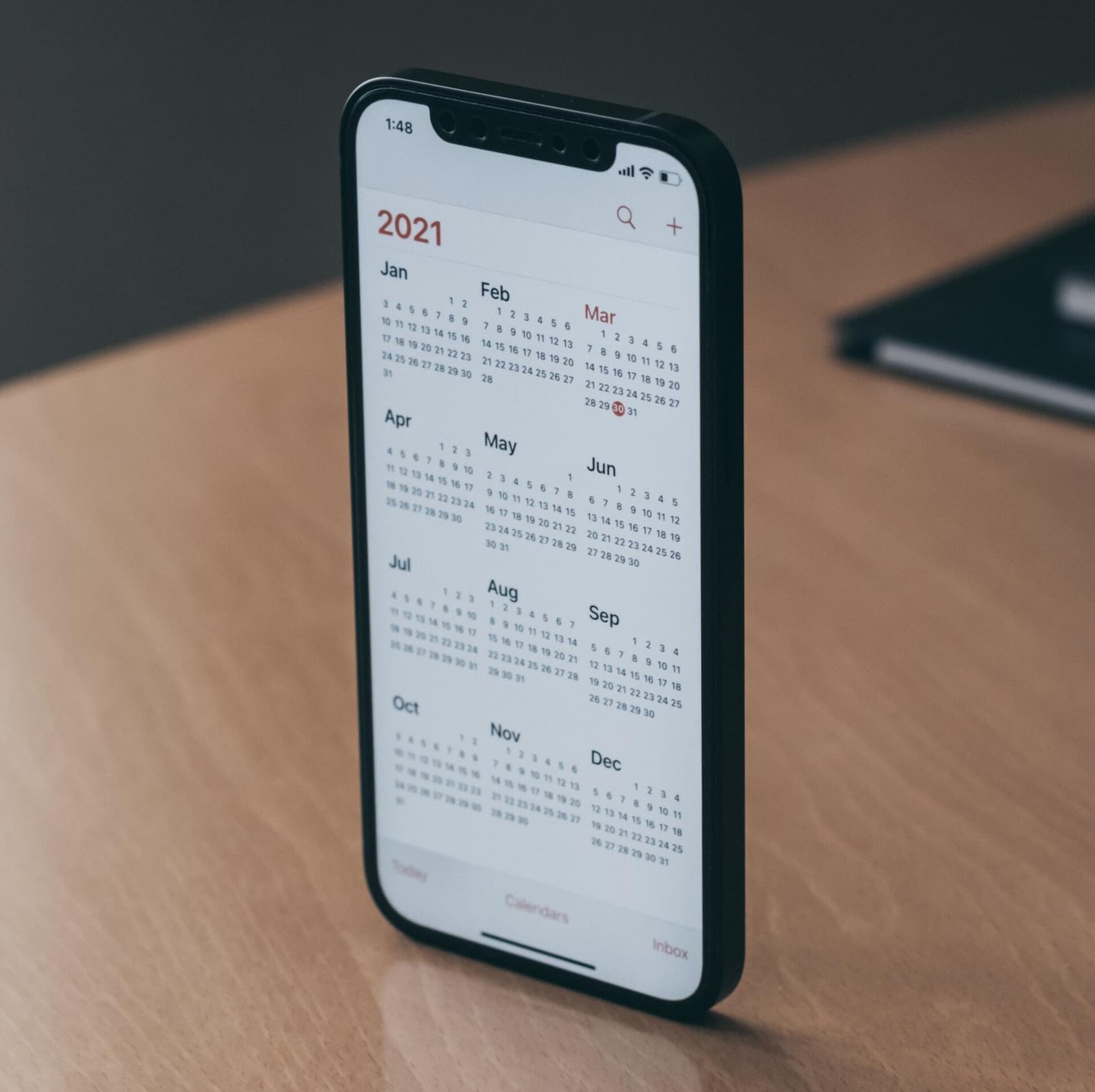 IPhone showing the 2021 calendar, recapping the tech buzzwords of 2021