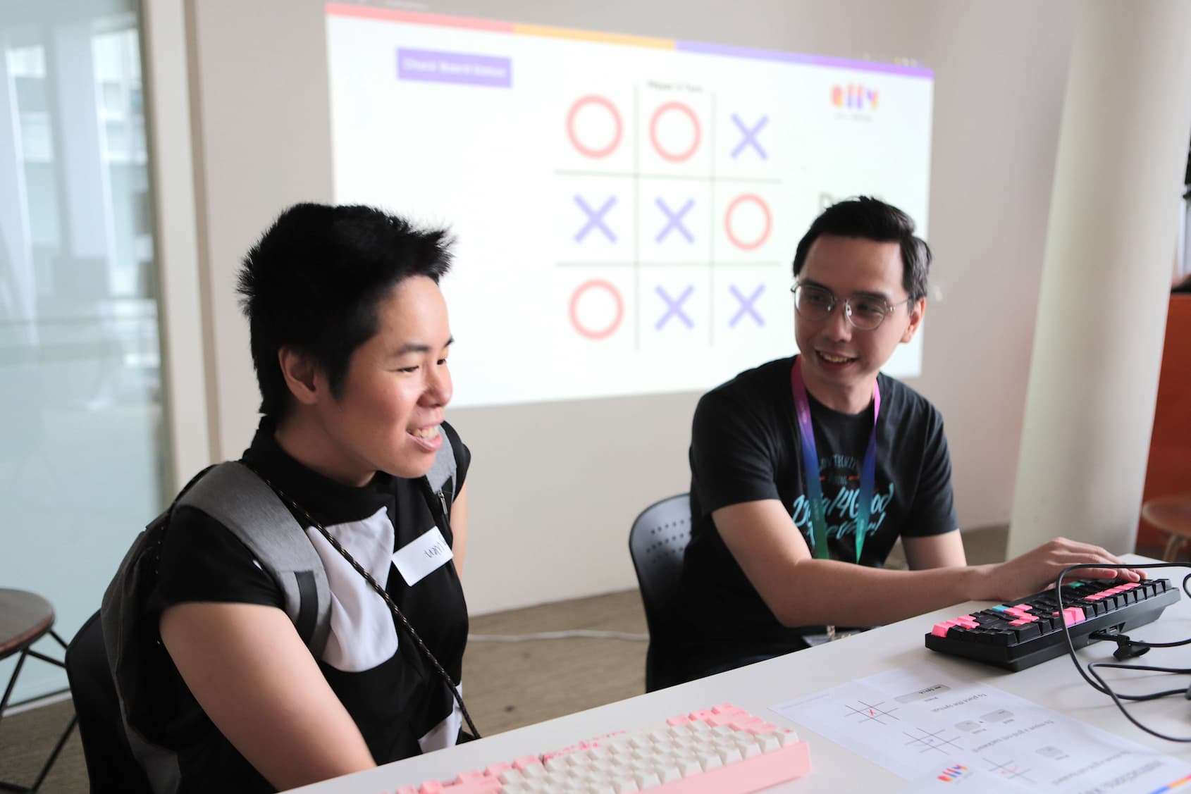 An A11y Week participant learning about screen reader accessibility at the A11y Tic Tac Toe booth.